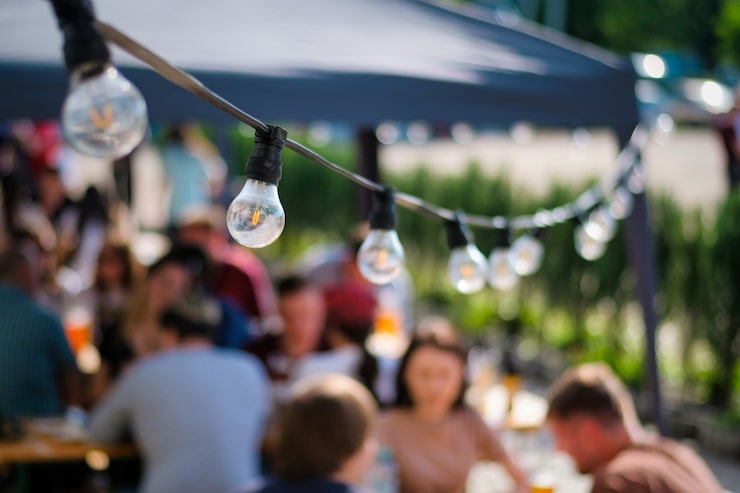 hanged lamps outdoor restaurant with multiple visitors background bbq 1268 17681[1]